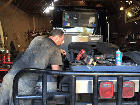 1. Working on the truck before the next race weekend.